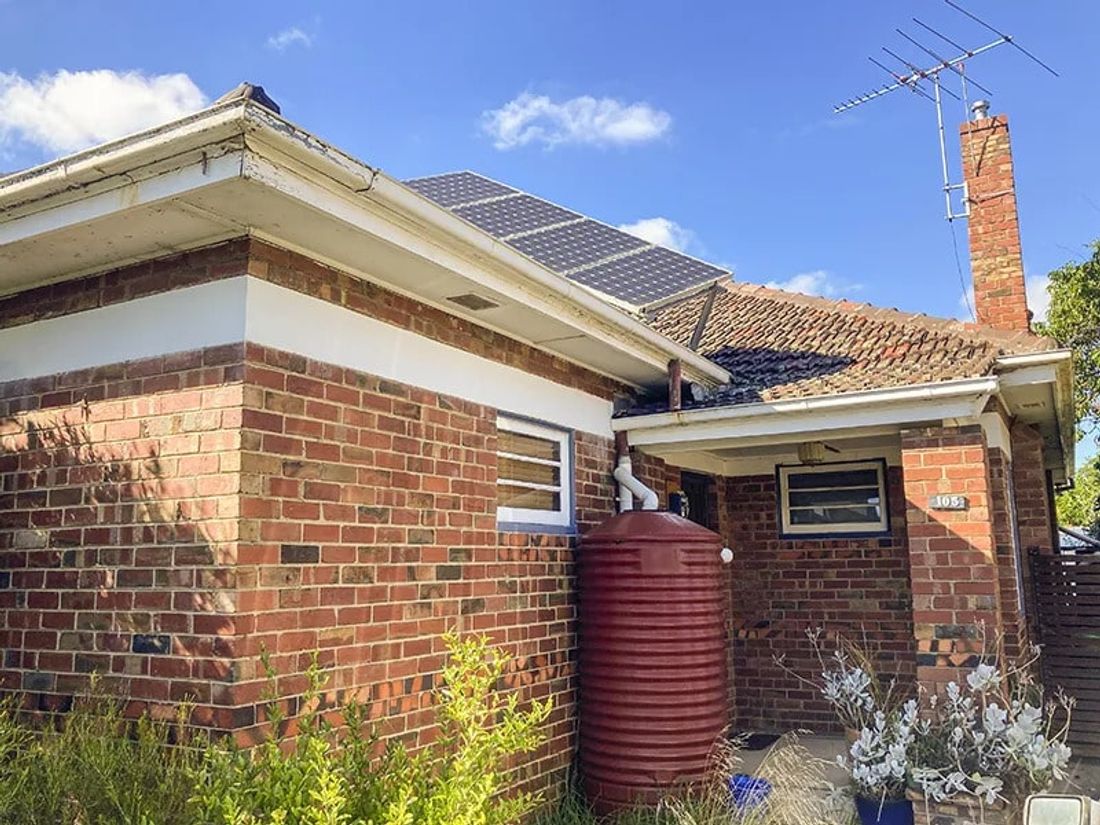 Rainwater tank installed at the side of a house
