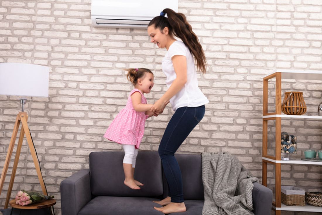 Mother and child playing in an airconditioned room