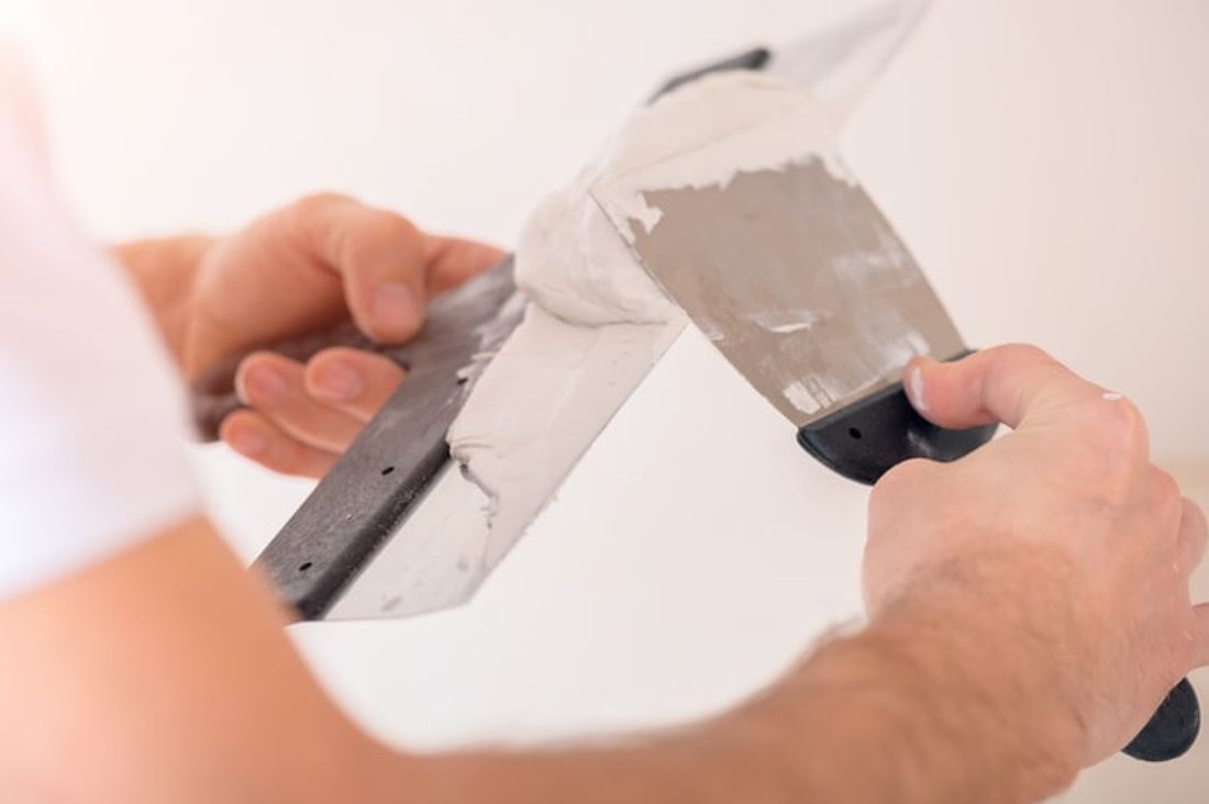 close up of a handyman using plastering tools