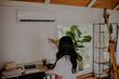 woman turning on her evaporative cooling unit