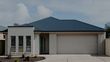 Modern home with a cream coloured automatic garage door