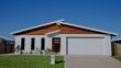 White and timber home with a double white garage door